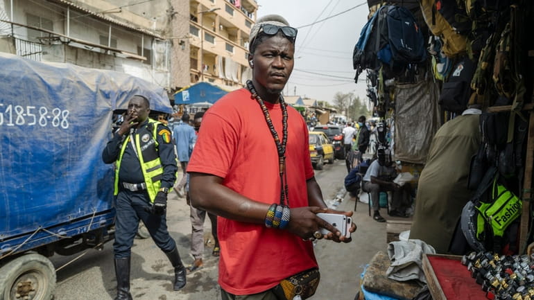 Gueva Ba sells used cell phones in Dakar's Colobane market...
