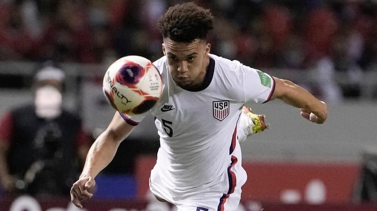 The United States' Antonee Robinson goes for a header during...