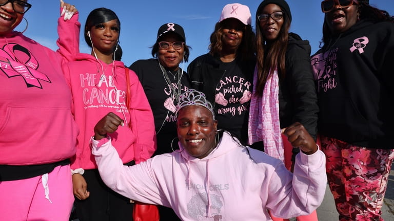 Breast cancer survivor Thynisha Alves, 47, of Amityville, center, with...