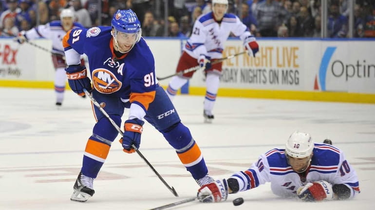 Marian Gaborik of the Rangers tries to knock the puck...