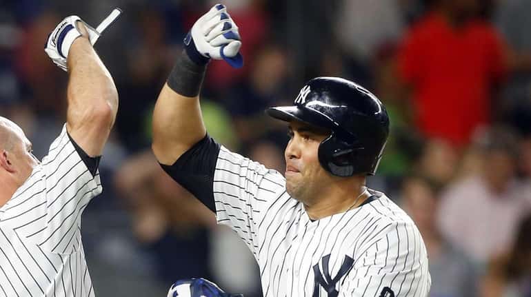 Carlos Beltran #36 of the New York Yankees celebrates his...