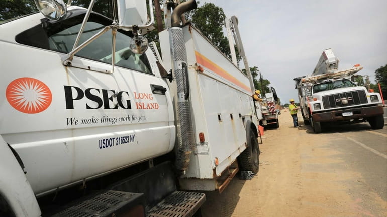 PSEG Long Island crews work to transfer power lines to...