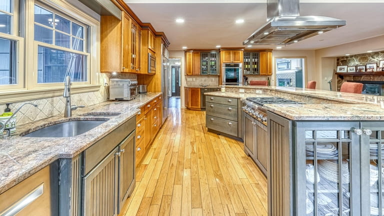 The oversized kitchen has stainless steel appliances and granite counters.