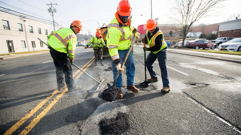 State workers repair potholes on Jericho Turnpike east of Route...
