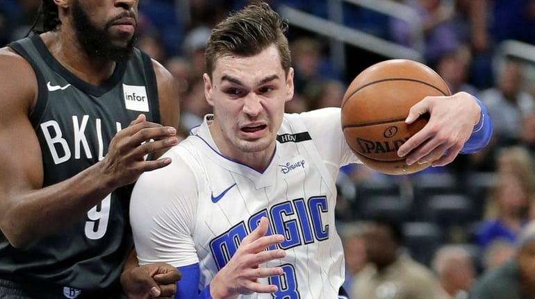 The Magic's Mario Hezonja makes a move to the basket...