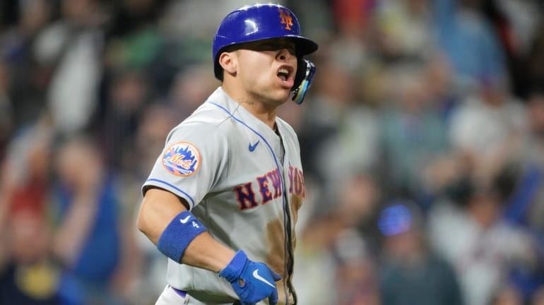 Mets' Francisco Alvarez reacts after hitting a three-run home run...