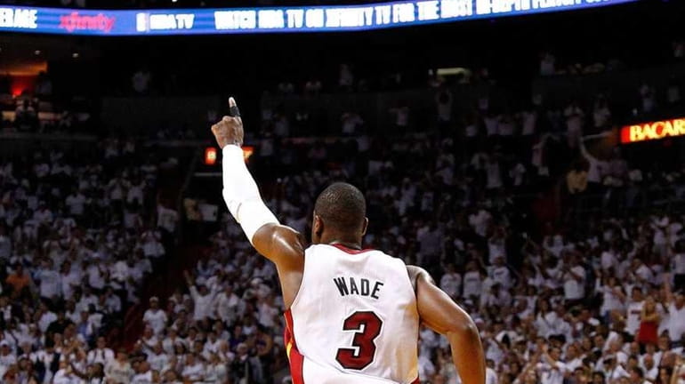 Dwyane Wade #3 of the Miami Heat reacts to a...