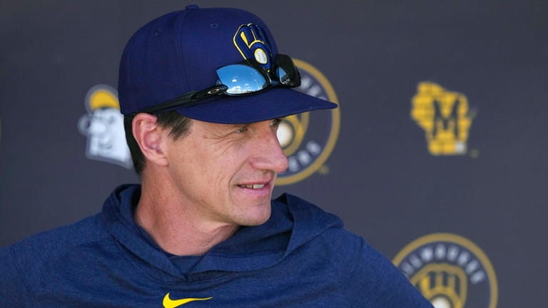 Milwaukee Brewers manager Craig Counsell pauses in the dugout prior...