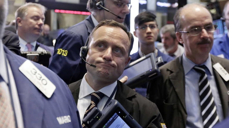George Baskinger, center, works with fellow traders on the floor...