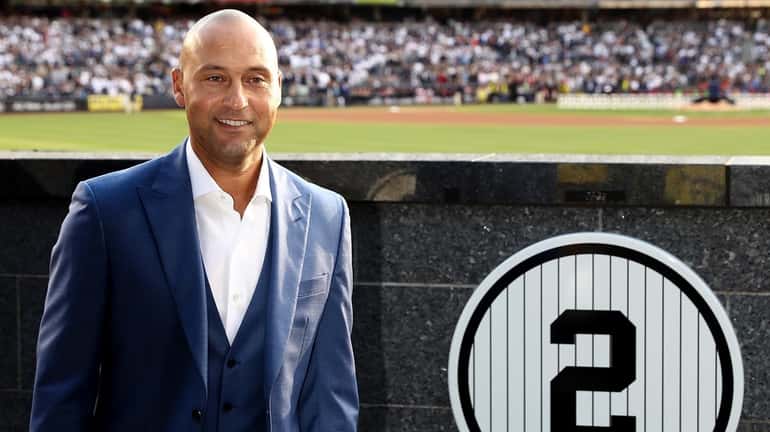 Retired New York Yankees captain Derek Jeter next to his...