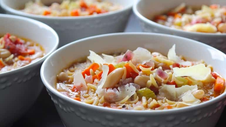 Pasta fagioli, with beans, broth and vegetables make a hearty,...