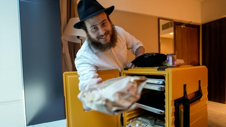 Eli Chitrik from Turkey shows bagel sandwiches at his hotel...