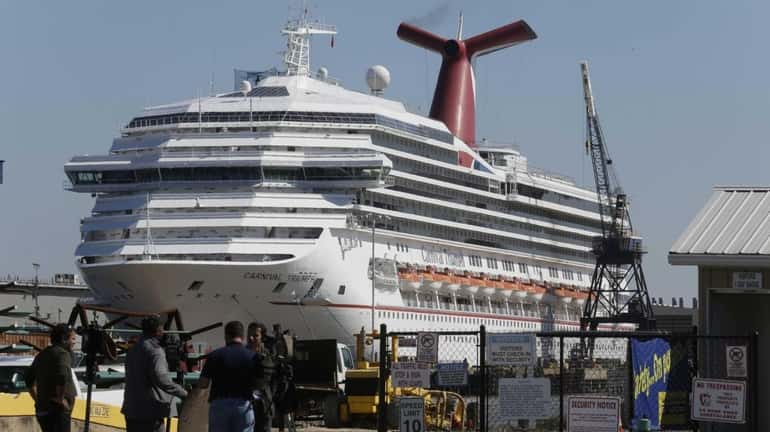The cruise ship Carnival Triumph is moored at a dock...