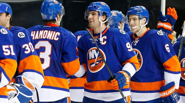 John Tavares (No. 91) celebrates with his teammates after defeating...