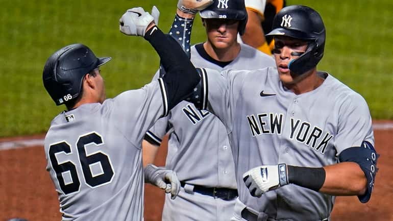 The Yankees' Aaron Judge, right, celebrates with Kyle Higashioka as...