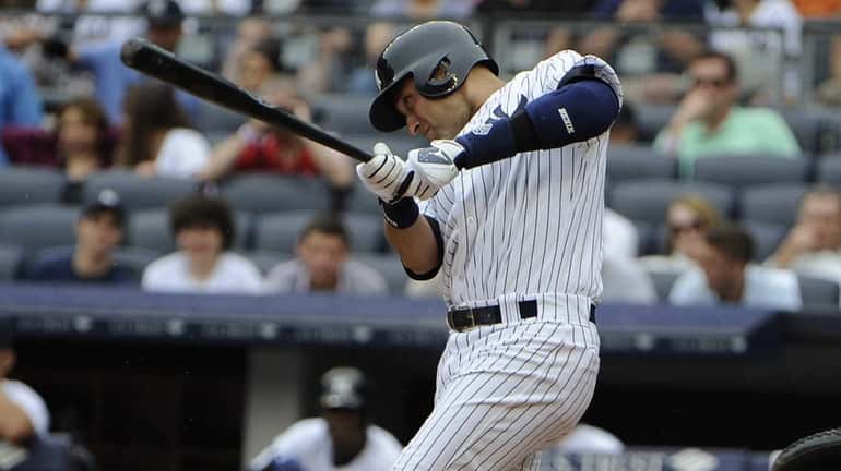 Derek Jeter hits a single in the third inning of...