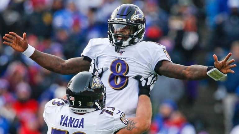 Ravens quarterback Lamar Jackson celebrates a 61-yard touchdown pass with...