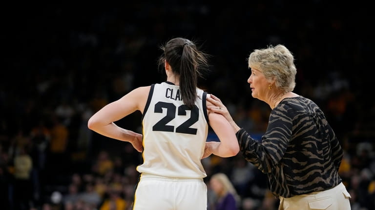 Iowa head coach Lisa Bluder talks with guard Caitlin Clark...