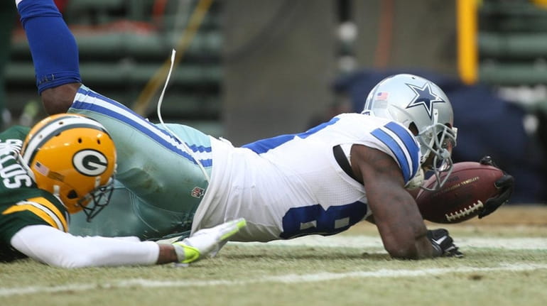 Cowboys wide receiver Dez Bryant dives for the end zone...