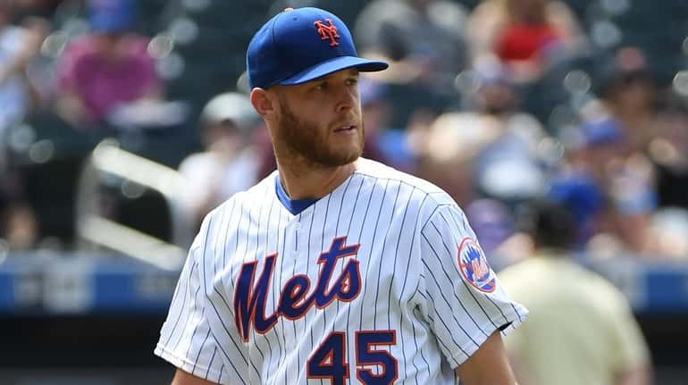 Mets starting pitcher Zack Wheeler walks to the dugout during...