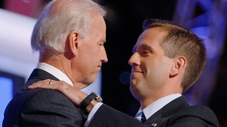 Then-Democratic vice presidential candidate Sen. Joe Biden, D-Del., left, embraces...