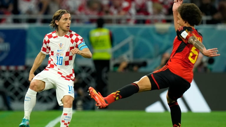 Croatia's Luka Modric, left, duels for the ball with Belgium's...