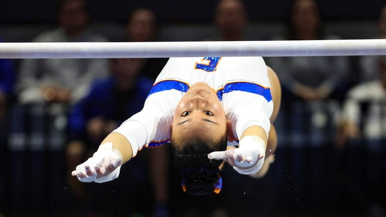 FILE - Florida's Leanne Wong competes on the uneven bars...