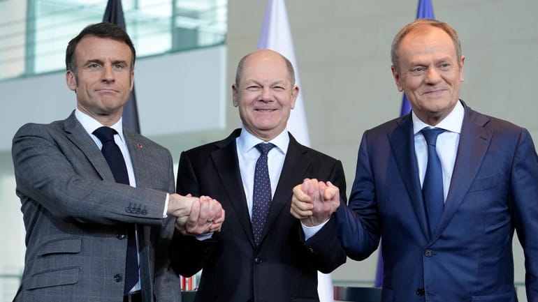 German Chancellor Olaf Scholz, center, French President Emmanuel Macron, left,...
