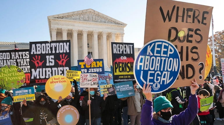 Pro- and anti-abortion protesters in front of the U.S. Supreme...
