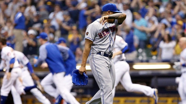 Mets pitcher AJ Ramos walks off the field after giving...
