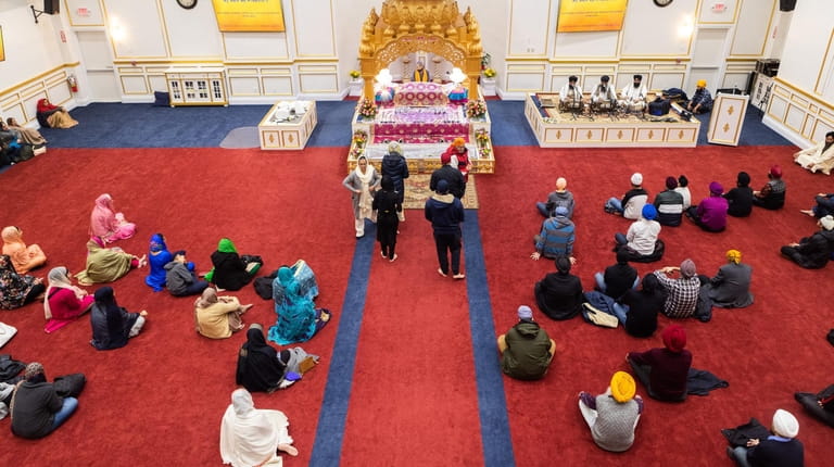 Worshippers attend an evening service led by Giani Amarjit Singh...