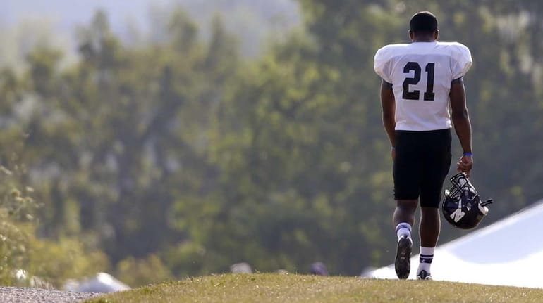 Northwestern football player Justin Jackson walks to practice at the...