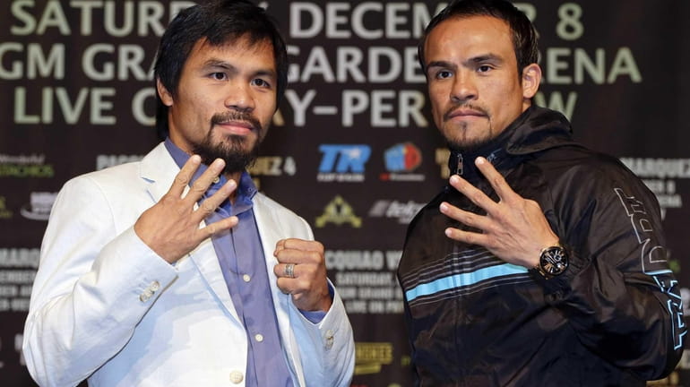 Manny Pacquiao, left, and Juan Manuel Marquez, right, pose for...