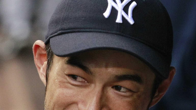 New York Yankees' Ichiro Suzuki smiles as he looks out...