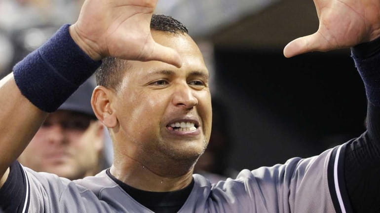 New York Yankees designated hitter Alex Rodriguez congratulates teammate John...