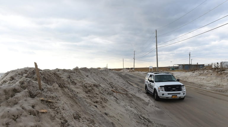 Dune Road in Southampton was flooded overnight, washing sand up...