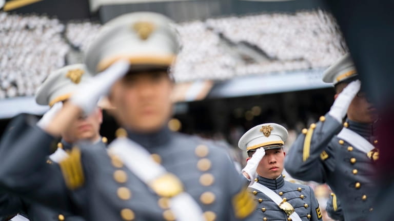 Graduating cadets salute during the graduation ceremony of the U.S....