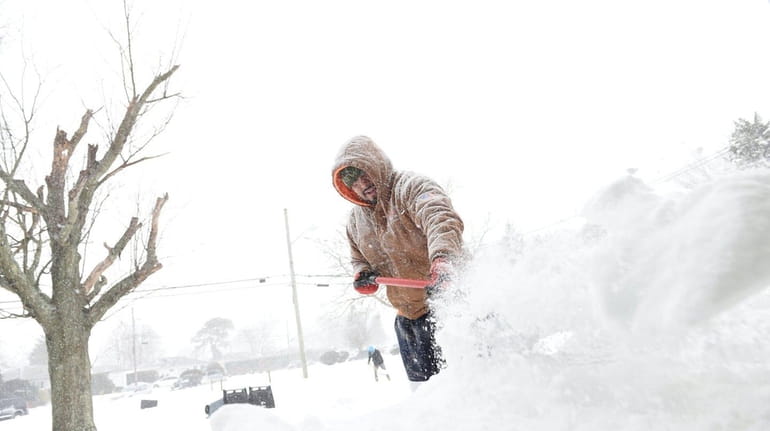 Alan Reibera shovels snow on Candlewood Road in Brentwood on...