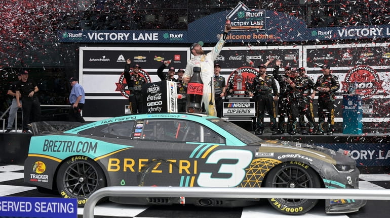 Austin Dillon celebrates in Victory Lane after winning a NASCAR...