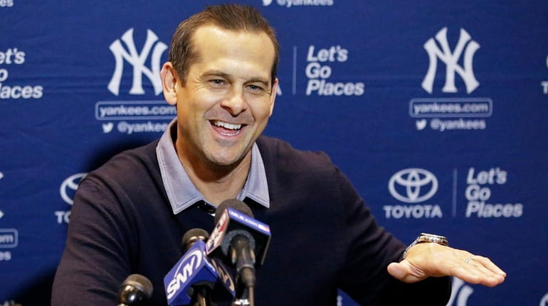 Yankees manager Aaron Boone talks with the media at the...