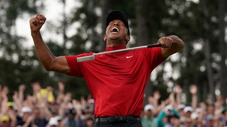 Tiger Woods reacts as he wins the Masters golf tournament...