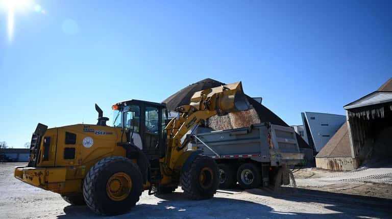 Town of Hempstead workers prepared for the weekend's expected snowstorm,...