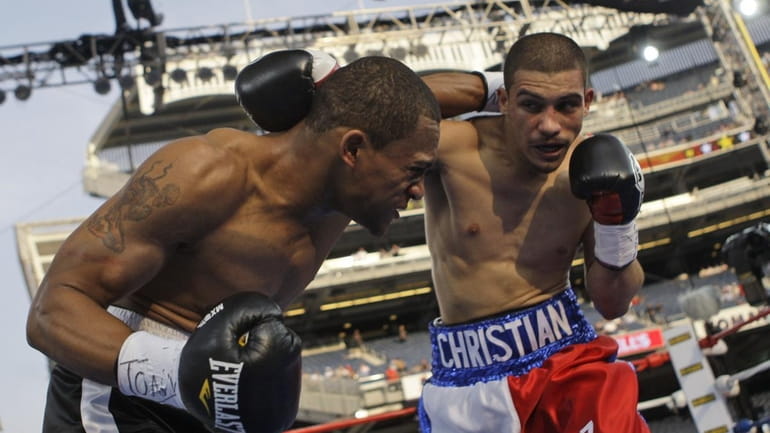 Jonathan Cuba, left, fights Christian Martinez, right, during the first...