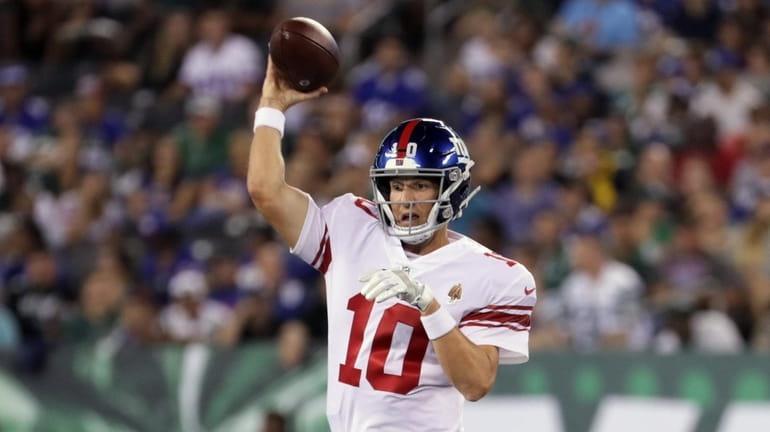 New York Giants quarterback Eli Manning #10 throws the ball...