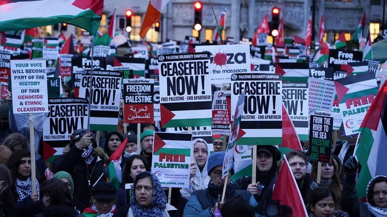 People take part in a Palestine Solidarity Campaign rally outside...