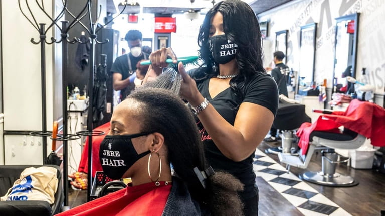 Natashia Jeré, owner of Jeré Hair Salon in Freeport, working on...
