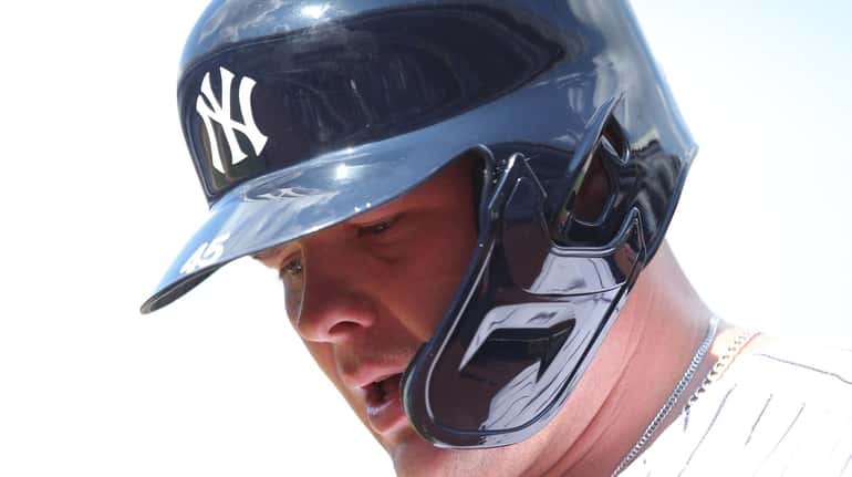 Yankees first baseman Luke Voit, wearing a faceguard after being...