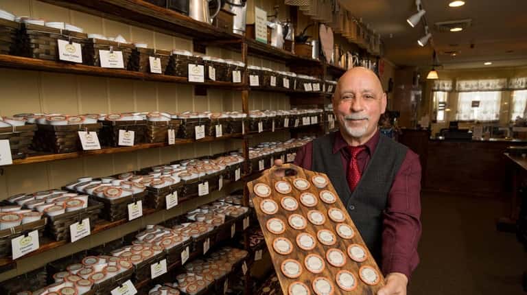 Gary Contes shows off the K-Cup wall at his shop, Village...