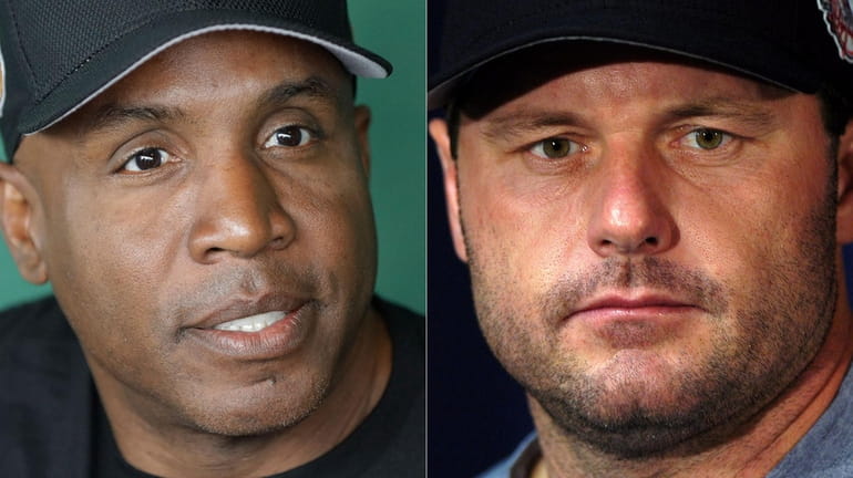 Barry Bonds (L), shown in a 2017 file photo, and...