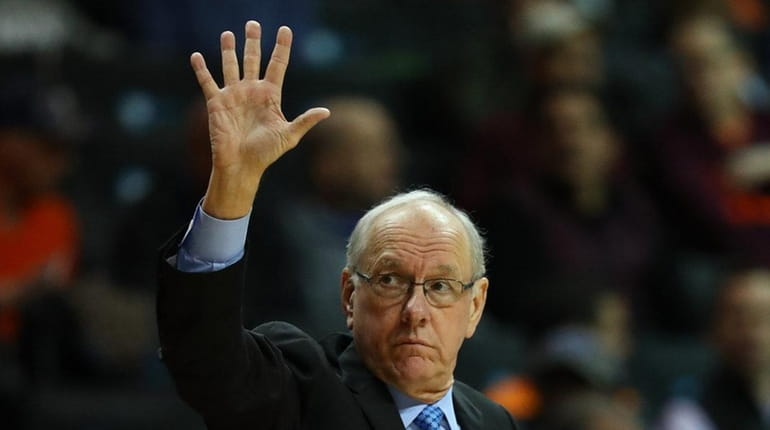 Head coach Jim Boeheim of the Syracuse Orange raises his...